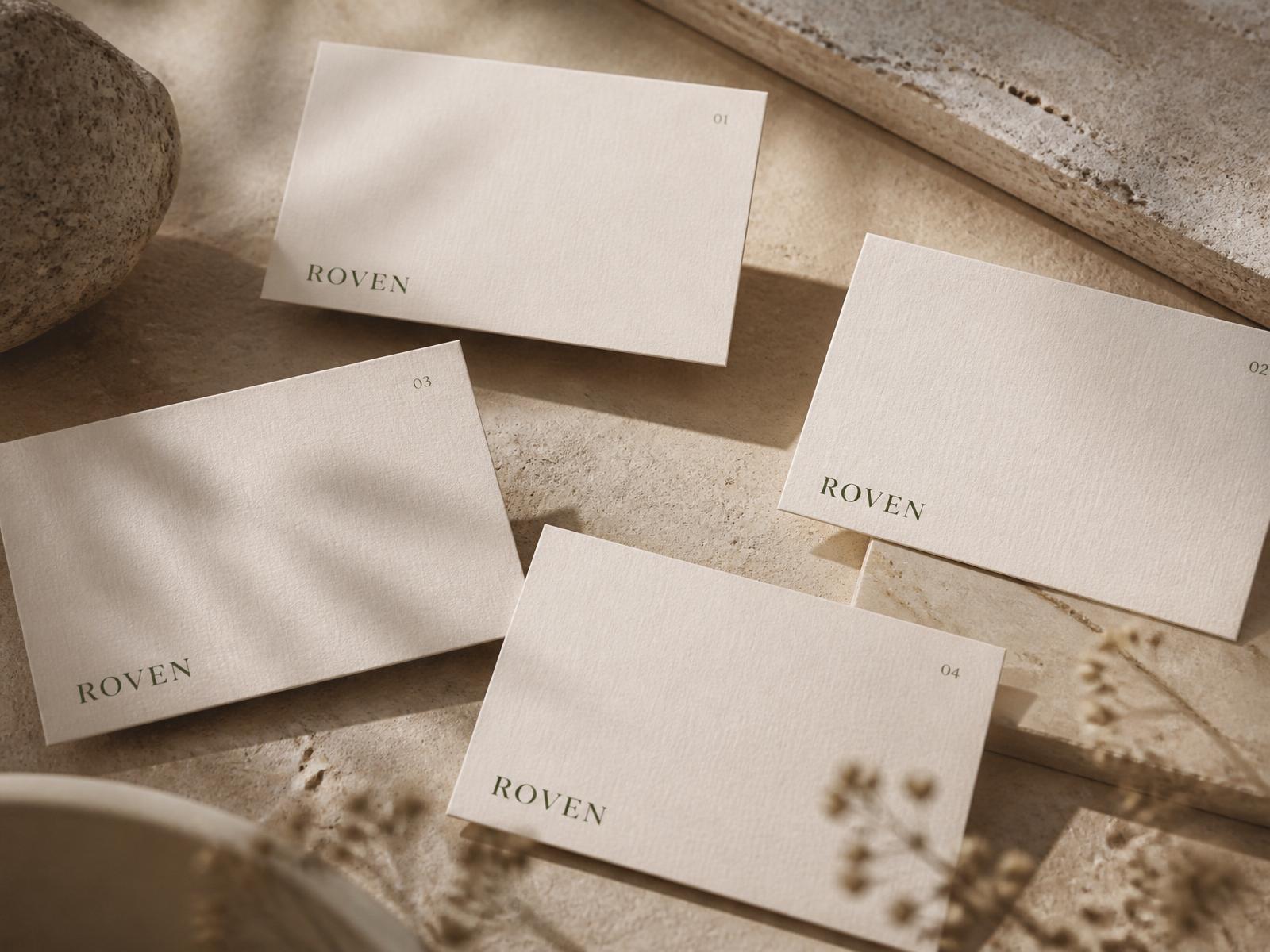 A collection of cream ROVEN Field Note cards arranged on natural travertine.